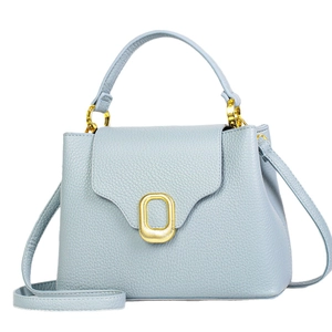 Elegant light blue leather handbag with gold twist lock and adjustable shoulder strap