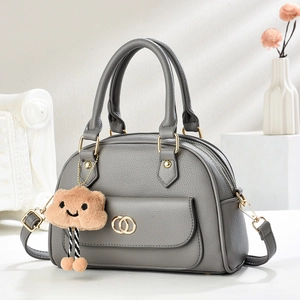 Minimalist grey litchi grain tote bag with gold rings and plush cloud charm