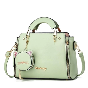 Mint green fashion handbag with cat charm and Danbaoly logo on a white background