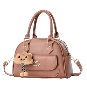 Taupe pebbled leather Boston bag with gold ring hardware and plush cloud charm