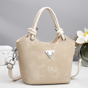 Retro beige bucket bag with triangular metal logo and knotted handle for crossbody use