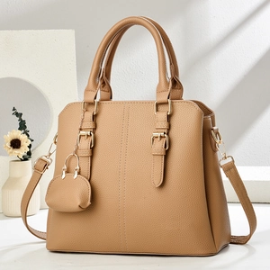 Elegant tan lychee leather handbag with golden hardware and matching coin purse