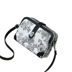 Three-layer crossbody bag with paisley embroidery and silver hardware detailing