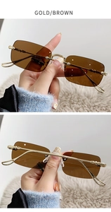 Détails de lunettes de soleil rectangles sans monture avec branches dorées gravées