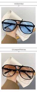 Detail view of oval ocean lens sunglasses in black blue and leopard print frames