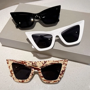 Retro cat-eye sunglasses set featuring black, white and tortoiseshell frames on display
