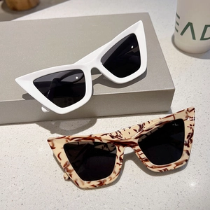 Detail of trendy white and tortoiseshell cat-eye sunglasses with UV protection lenses