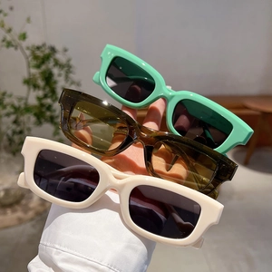 Detailed view of square thick-frame sunglasses in mint green, olive green, and beige