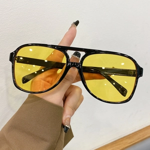Retro aviator sunglasses with black double-bridge frame and yellow transparent lenses