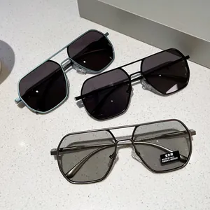 Detailed close-up of geometric metal sunglasses showing photochromic lenses and frame texture