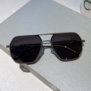 Close-up of geometric aviator sunglasses with dual-bridge metal frame and size parameters