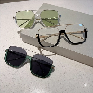 Detail of square oversized sunglasses with metal double bridge and mixed material frames