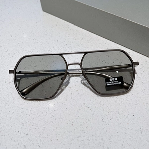 Macro detail of geometric pilot sunglasses with gray metal frame and photochromic lenses