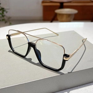Detail view of stylish black and gold square aviator frame with metallic double bridge