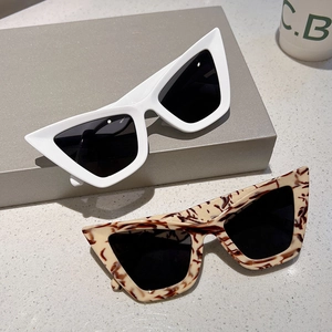 Retro cat-eye sunglasses set in white and leopard frames with UV protection lenses