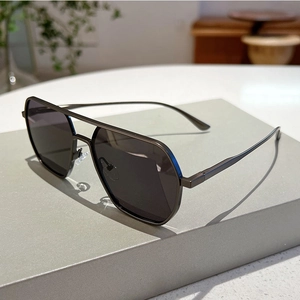 Detail shot of vintage grey metal navigator sunglasses on a modern geometric display