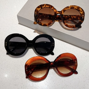 Classic round oversized sunglasses in leopard, black, and amber frames with metal accents