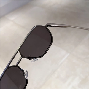 Macro detail of geometric metal frame sunglasses with adjustable silicone nose pads