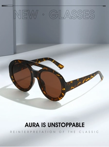 Detail of tortoise shell sunglasses with double bridge and large oval lenses