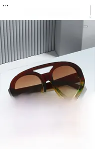 Detail of retro oval aviator sunglasses with gradient lenses and leopard print frame