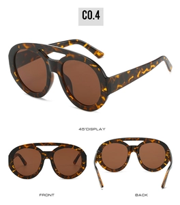 Detail view of tortoiseshell oval sunglasses with vintage double bridge and brown lenses