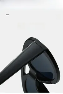 Detail of high-elastic black frame hinges on vintage oval double-bridge sunglasses