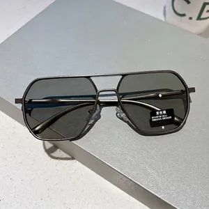 Modern metallic polygon aviator sunglasses with dark grey photochromic lenses for men