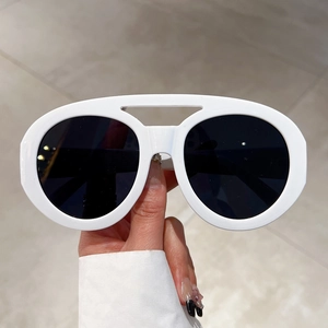 White oval thick frame sunglasses with double bridge design and dark lenses