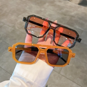 Close-up of stylish oversized hexagonal sunglasses with double bridge and gold rivets