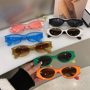 Detailed flat lay of colorful Y2K cat-eye sunglasses with glitter finish in seven colors