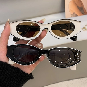 Detail shot of vintage cat-eye sunglasses in black and white frames with model KD97082