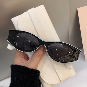 Detail of vintage cat eye sunglasses with black frame and white contrast outline