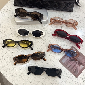 Flat lay of vintage cat eye leopard sunglasses collection on marble background