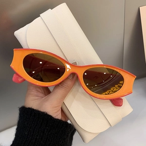 Modern cat-eye orange sunglasses with oval frames and a premium cream leather case
