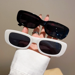 Close-up of retro square sunglasses in black and white with UV protection lenses