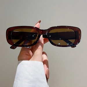 Detail view of vintage rectangular sunglasses with dark brown lenses and tortoiseshell frame