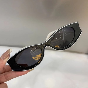 Detail of vintage black cat-eye sunglasses with thick frames and stylish white contouring