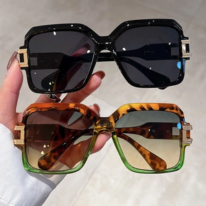 Classic black and tortoiseshell square sunglasses with gold metal decorative accents