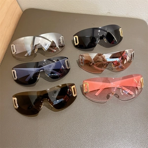 Detail of Y2K shield sunglasses showing six colorful lenses and gold D-shaped crystal decor