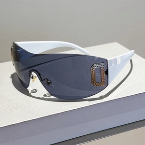 Detail view of white frame Y2K sunglasses featuring a crystal-inlaid metal D emblem