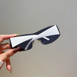 Detail of futuristic Y2K sunglasses with white geometric frames and black shield lens