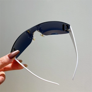 Detail view of Y2K wraparound sunglasses with blue lenses and white frame arms