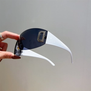 Detailed view of Y2K wraparound sunglasses featuring a sparkling rhinestone D logo on white arm