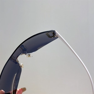 Macro view showing the sturdy hinge and white temple connection of Y2K shield sunglasses