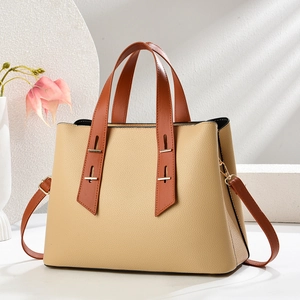 Minimalist beige pebble leather handbag with brown straps and gold hardware details