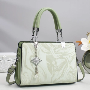 Green and white marble textured tote bag with elegant silver tassel and pearl charm