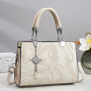 Detail of marble pattern PU leather handbag with silver chain and pearl pendant charm