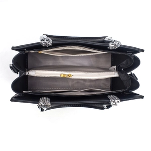 Interior view of black tote bag showing multiple compartments and grey chevron lining