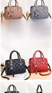 Detailed view of quilted faux leather handbags in khaki, grey, black and red colors