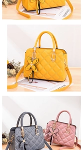 Detail view of quilted leather handbags with leather bow charms in yellow, gray, and pink